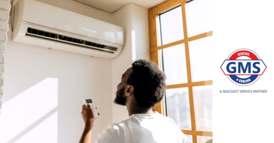 young man turning on air conditioner